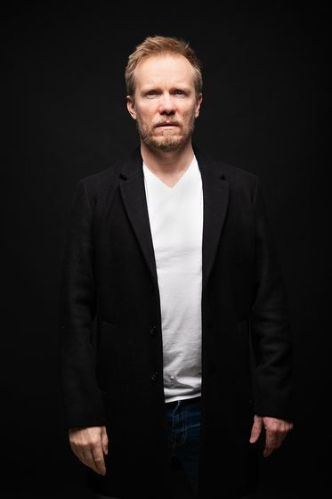 Matti Boustedt, studio portrait facing camera, black coat
