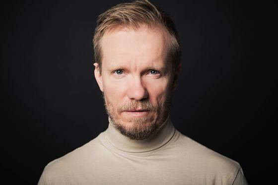 Matti Boustedt, close-up headshot in beige turtleneck